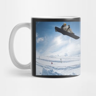 Snowboarder jumping against blue sky Mug